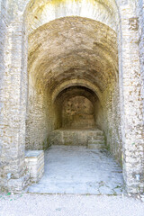 Obraz premium Part of ruins of arch-shaped structure of Ottoman architecture at Gjirokaster castle. Gjirokastner-Albania.