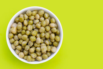 Canned green peas on white background.