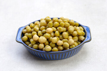 Canned green peas on white background.