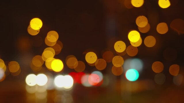 Twilight Rainy Urban scene. Cityscape lights bokeh, Car Trails, Traffic at dask city, Night Drive