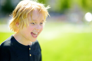 Portrait of happy preteen boy during walks on sunny summer day - 791185725