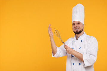 Happy professional confectioner in uniform holding whisk and spatula on yellow background. Space...