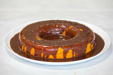 carrot cake with chocolate icing in selective focus