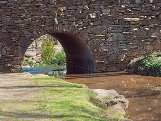 Stone bridge in springtime with stream flowing through it