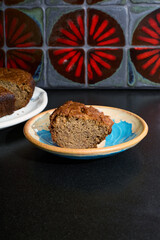 Fresh cake dessert on a plate with a beautiful red tile background. 