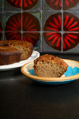 Fresh cake dessert on a plate with a beautiful red tile background. 