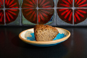 Fresh cake dessert on a plate with a beautiful red tile background. 