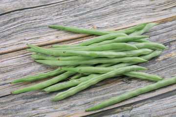 Green beans on wooden background. Healthy vegetarian food Natural products. Fresh harvest bean organic meal