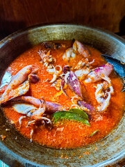 Cumi Balado or red chili squid. one of the typical Minangkabau dishes in Indonesia, fresh squid cooked with spicy chili sauce.