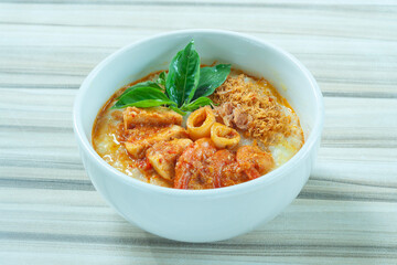 Seafood porridge consist of white rice porridge, shrimp, squid, sliced beef.