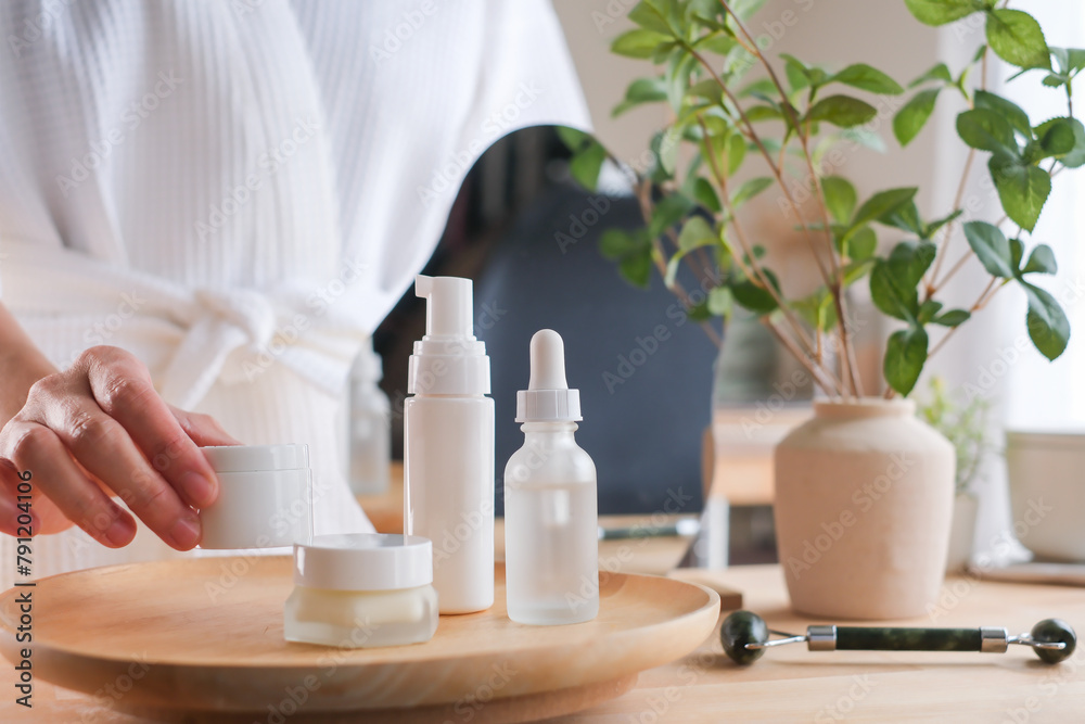 Wall mural a woman holds the skincare jar. for beauty, wellness, and cosmetic concept.