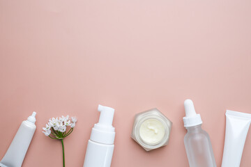 The skincare and cosmetic serum on pink flatlay background.