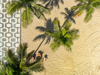 Aerial top down view of palm trees on Ipanema Beach with famous mosaic boardwalk