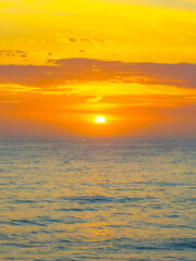 Fototapeta premium Hazy Summer Sunrise at the seaside with high cloud