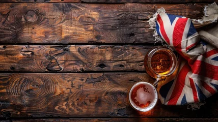 Rolgordijnen Glass of beer next to British flag on wooden table © Татьяна Макарова