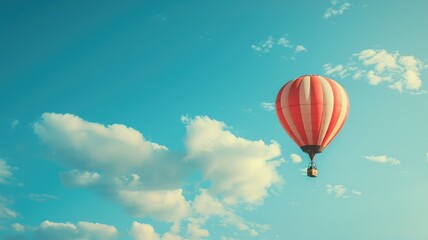 Red and white striped hot air balloon floating in clear blue sky with fluffy clouds