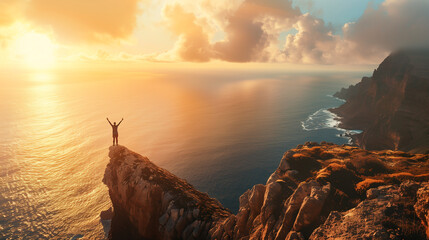 A man stands on a hill overlooking the ocean, with the sun shining brightly on him. He is holding his arms up in the air as if he is celebrating or expressing joy. Concept of freedom and happiness - obrazy, fototapety, plakaty