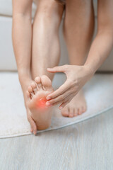 Arthritis and Muscle Pain Relief Cream concept. woman having barefoot pain at home. Foot ache due to Plantar fasciitis and waking longtime. Health and medical