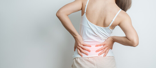 woman having back body ache during at home. adult female with muscle pain due to Piriformis...
