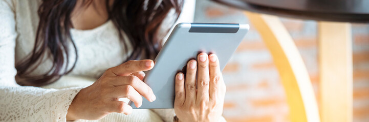 Banner Asian woman using digital tablet shopping online, call, texting message internet technology lifestyle smiling face. Banner woman touch smart tablet hands using mobile app home with copy space