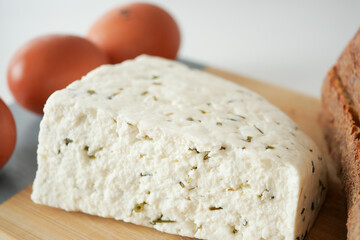 close up of fresh cheese, egg and bread on table 