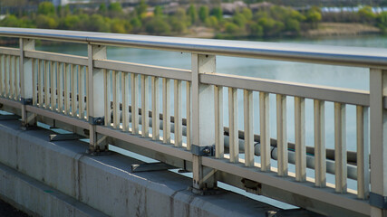 Safety railing fence on a bridge near the riverside