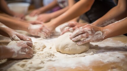 Obraz na płótnie Canvas Close-up of a group of students kneading dough on floured surfaces during a bread-making workshop, focusing on the hands and dough. 