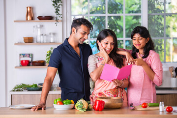 Mother's day or woman's day celebration of Indian small family in kitchen
