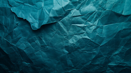 Crumpled dark teal paper creating an intricate textured surface.