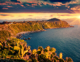 Dramatic sunrise on Milazzo cape with nature reserve Piscina di Venere, Sicily, Italy, Europe. Astonishing spring seascape of Mediterranean sea. Beauty of nature concept background. - obrazy, fototapety, plakaty