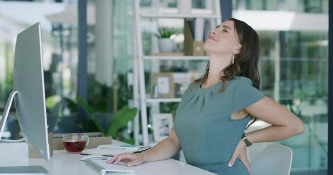 Business woman, computer and backache in pain, stress or discomfort sitting on chair at office desk. Frustrated female person with sore spine, back or muscle tension from inflammation at workplace