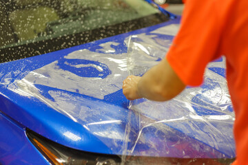 The process of installing PPF on the hood of the car.PPF is a protective film for paint that...