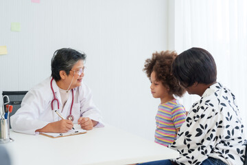 Senior female doctor nearing retirement age Counseling is being given to girls of various...