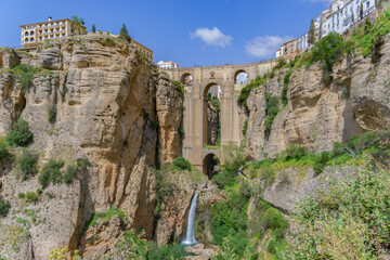 Fototapeta na wymiar ronda ,malaga, spain 04/18/2023 new bridge over the cliff with a waterfall of the river guadalevin