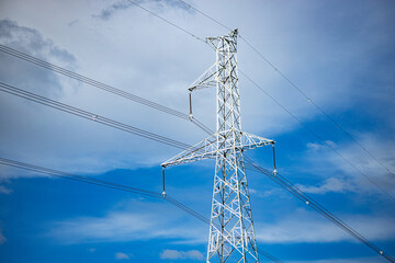 High voltage post. High voltage tower on blue sky background.