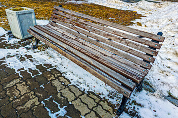 An empty park bench on a spring day