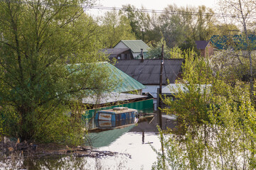 Flood in Kazakhstan. A flooded car and houses in a dacha area. The river overflowed its banks....