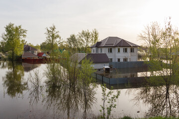 Flood in Kazakhstan. Flooded yard and two-story house in a dacha area. The river overflowed its...