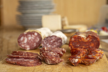 chopping board of various salamis