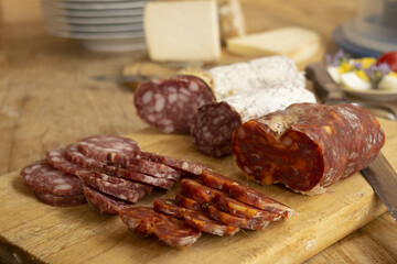 chopping board of various salamis
