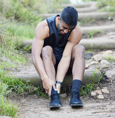Fitness, man or runner with ankle pain in forest to exercise, body training injury or outdoor...