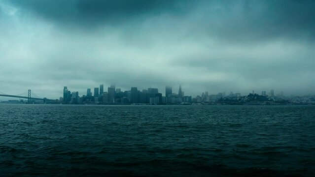 Incredibly dark, ominous, and dramatic aerial shot of the New York City skyline in low clouds and heavy fog.
