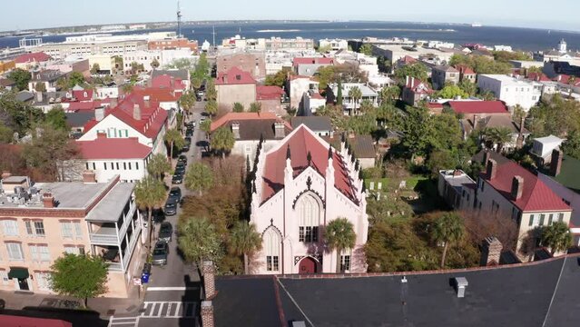 Low push-in aerial shot of the ornate French Huguenot Church in Charleston, South Carolina. 4K