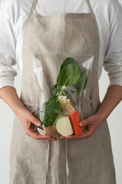 フードキットを両手で抱えた女性