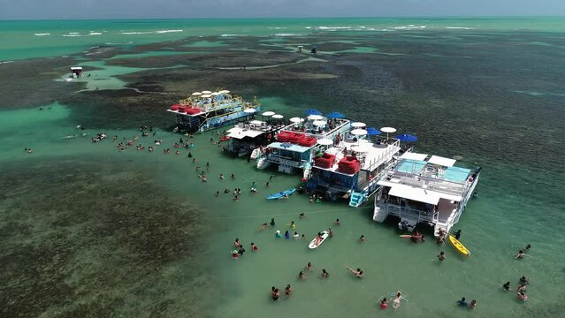 Aerial view of tourist boat in the Seixas natural pools, formed during low tide in a reef 1 km off the coast of Seixas Beach - Jo&atilde;o Pessoa, Para&iacute;ba, Brazil