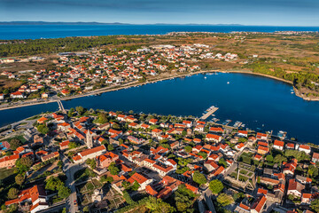 Nin, Croatia - Aerial panoramic view of the historic town and small island of Nin with blue Adriatic sea on a sunny summer morning in Dalmatia region of Croatia