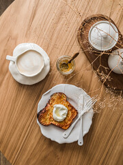 Delicious breakfast, dessert, snack - coffee and baked French toast with yogurt on a wooden table, top view - 791315191