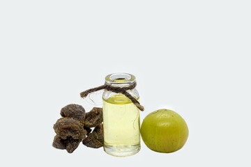 Amla Oil or Indian Gooseberry Fruit or Amla Candy Isolated on White Background with Copy Space, Also Known as Emblica Myrobalan or Phyllanthus Emblica