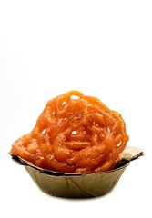 Closeup of Jilapi or Jalebi in Disposal Leaves Bowl Isolated on White Background with Copy Space, Also Known as Zalabia or Mushabak