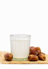 Khejur Ras or Date Palm Tree Juice in Glass with Phoenix Dactylifera Fruit with Leaves Isolated on White Background with Copy Space, Also Known as Date Palm Sap or Khejur Rosh